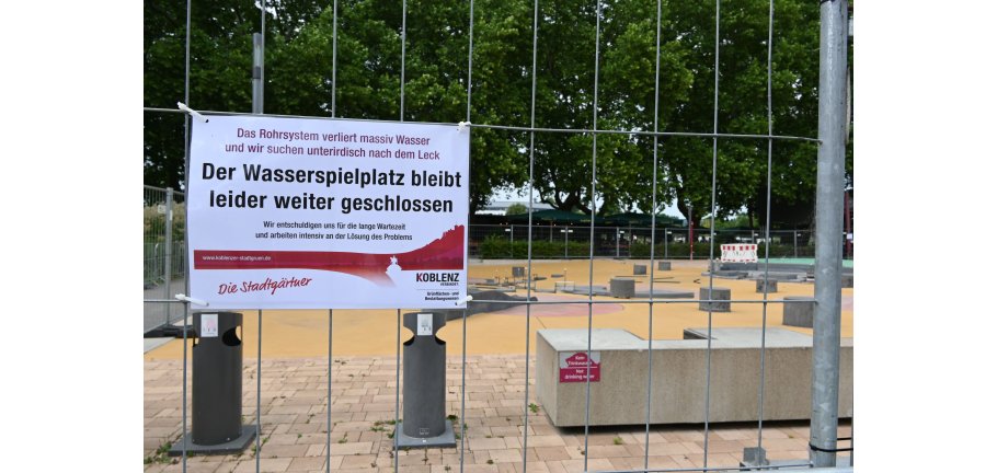 Blick auf einen Spielplatz durch einen Bauzaun.